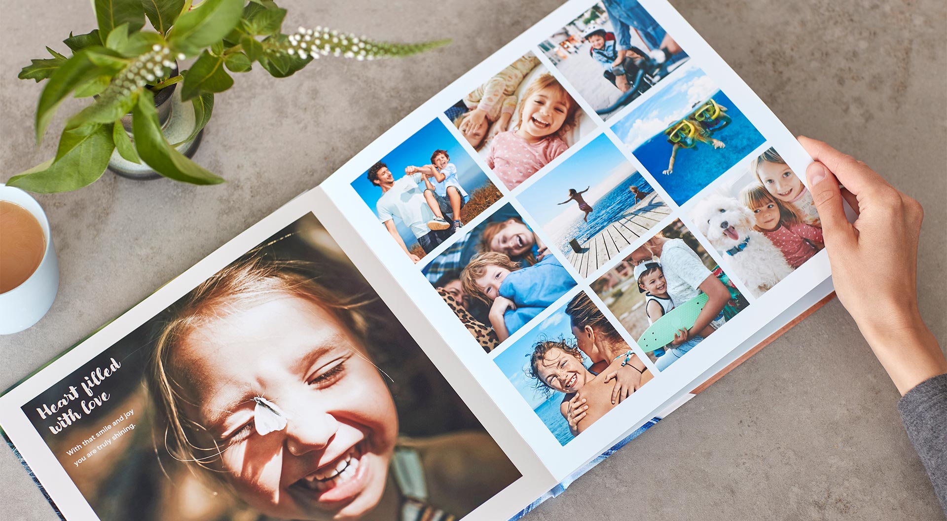 Photo shows a spread of a photo book. On the left page is a picture of a child and on the right page is a collage of vacation photos.