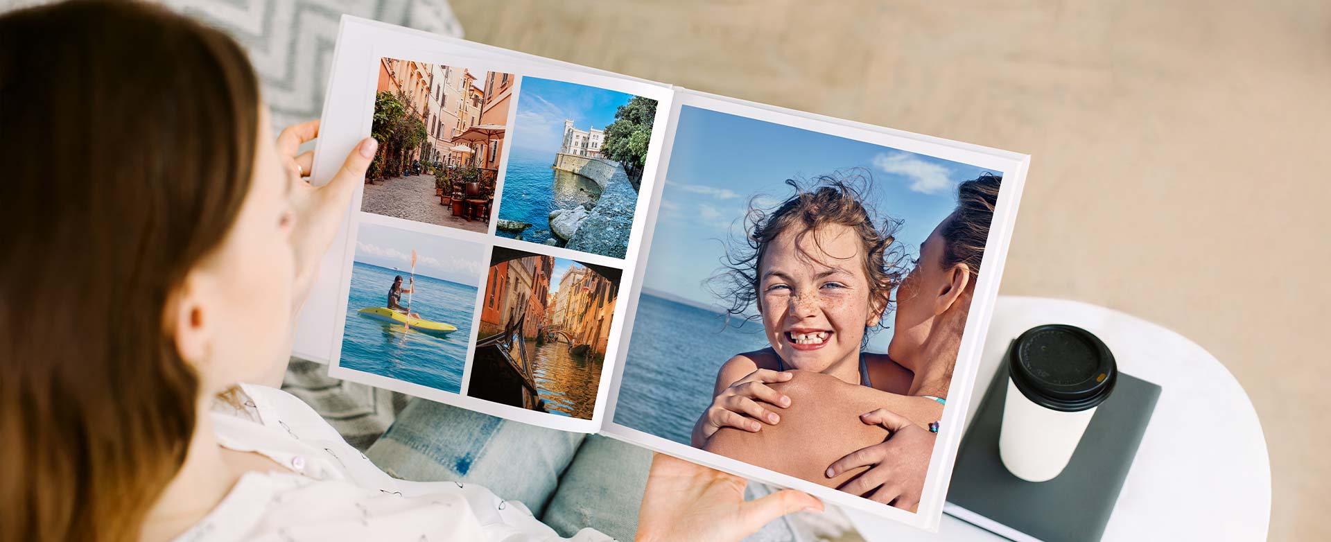 A woman is looking at a travel photo book with holiday pictures.